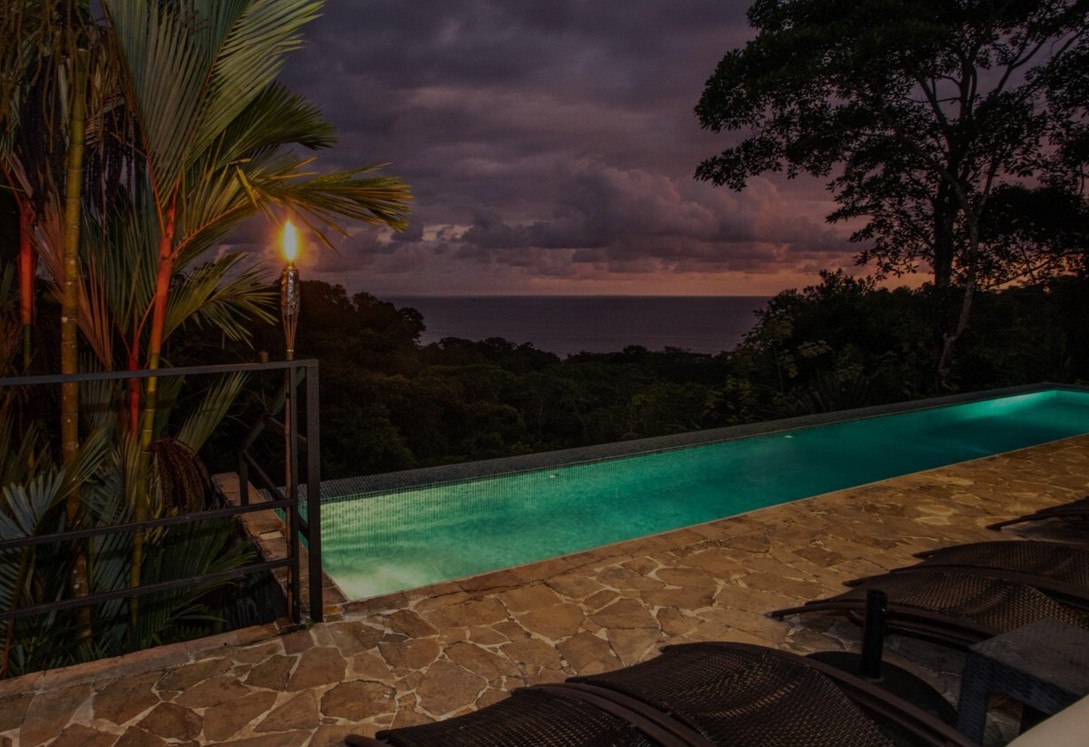 Tiki Villas Rainforest Lodge pool by night